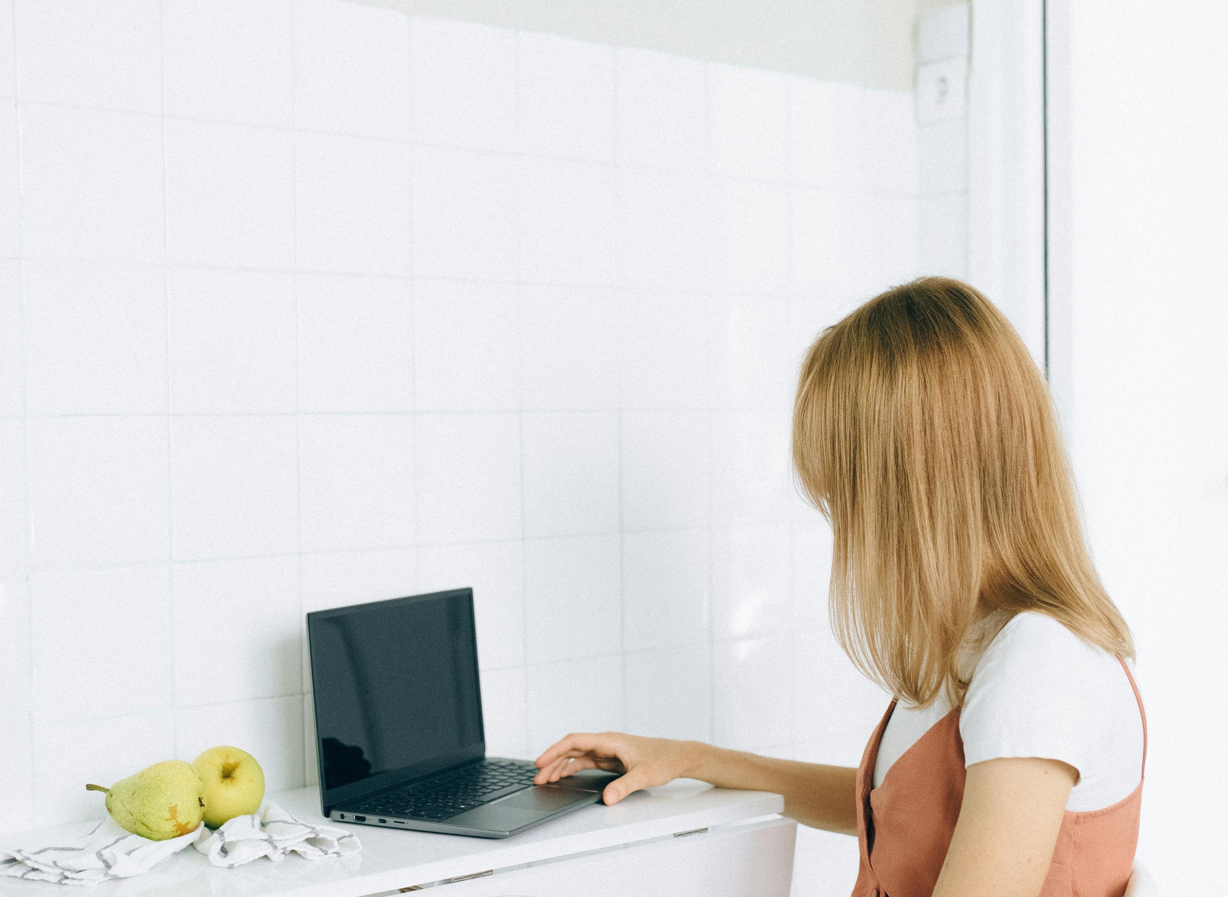Portrait Photo of A Woman Using Her Laptop At Home