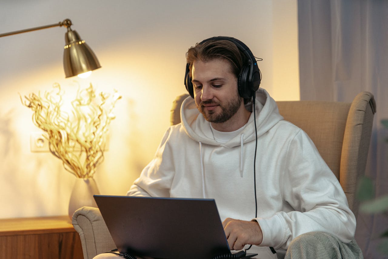Portrait Photo of A Man using Laptop at Home