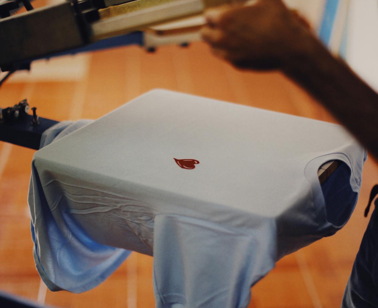 Person Printing a Design on a T-Shirt