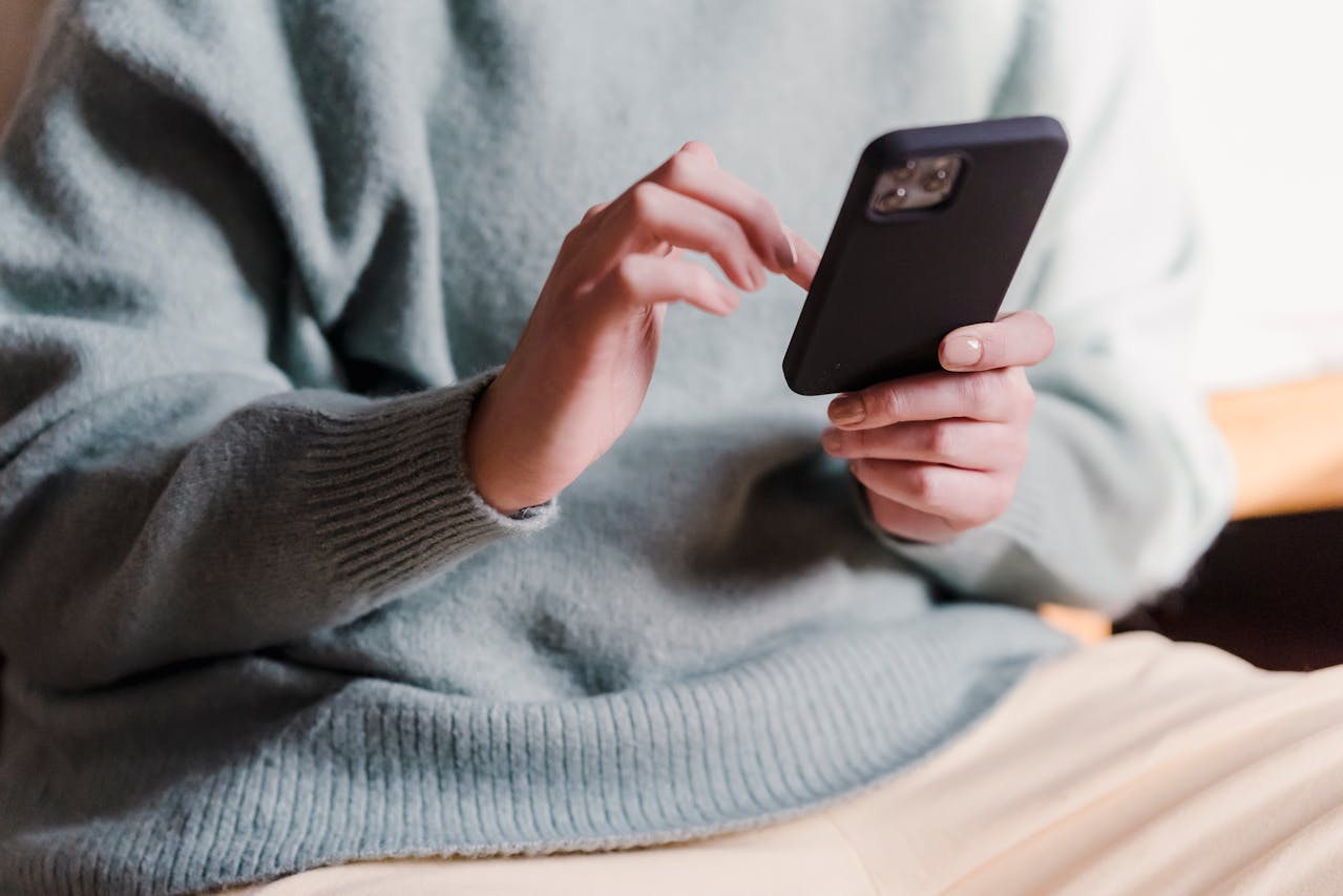 Close Up Photo of Woman surfing internet with mobile phone
