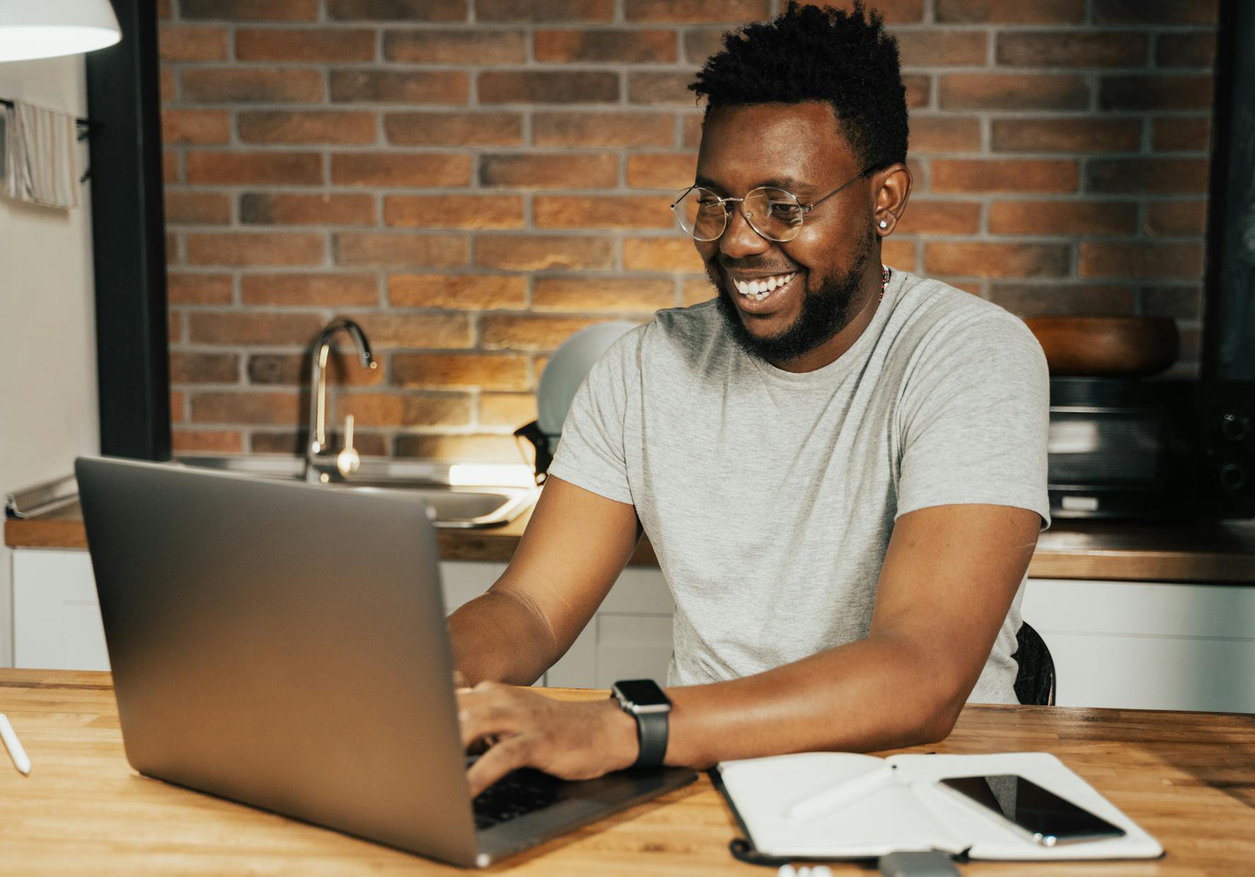 Portrait Photo of Man in gray t-shirt Using a Laptop