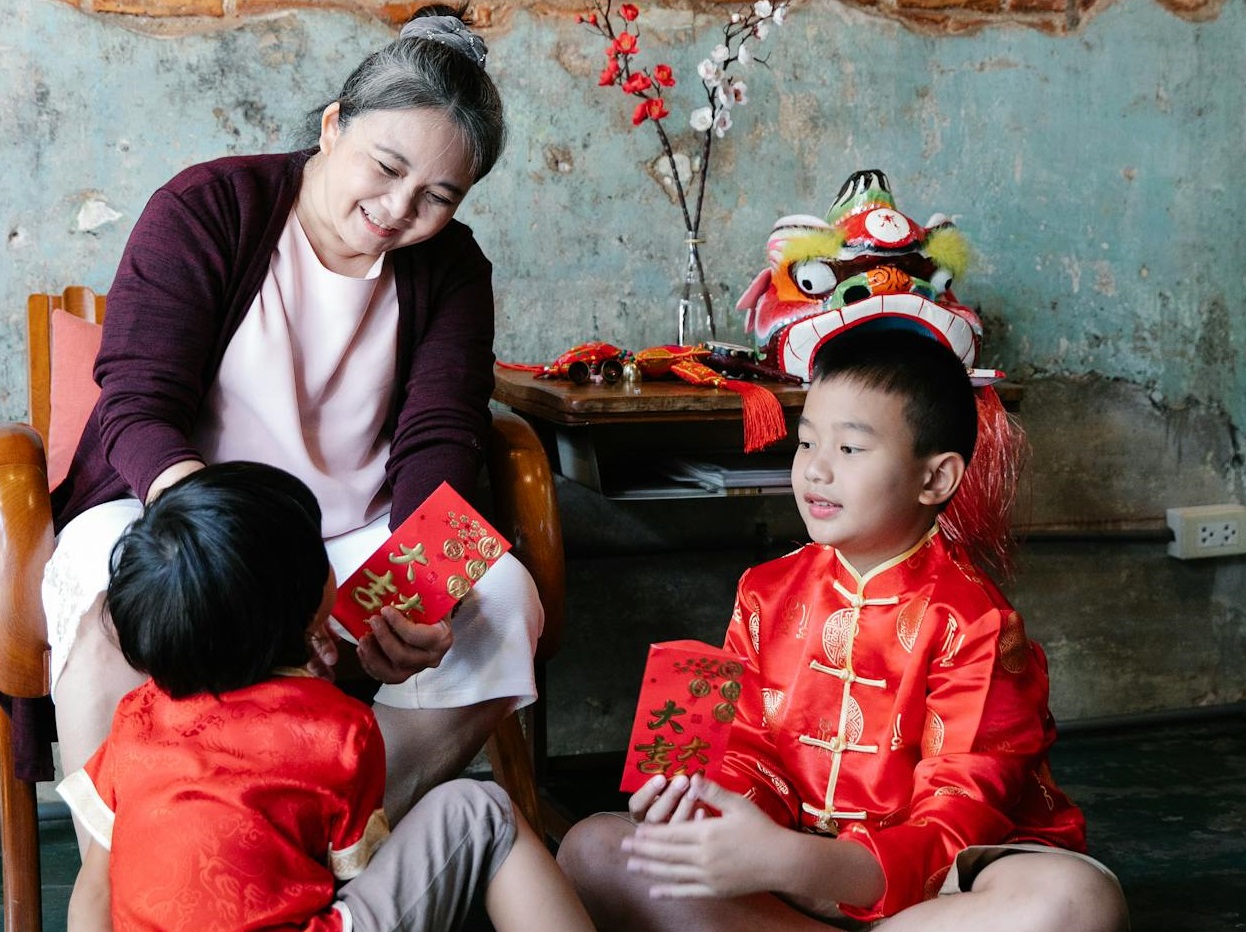 Senior woman playing with two kids.