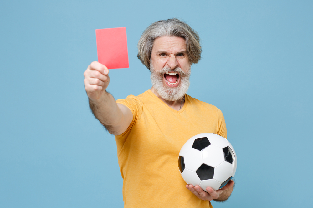 Elderly gray-haired mustache bearded Referee man in yellow t-shirt