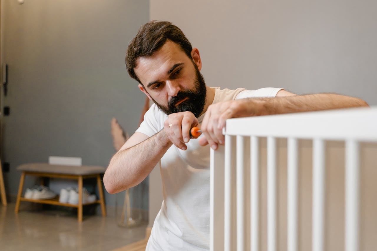 Man in White T-shirt Assembling Furniture