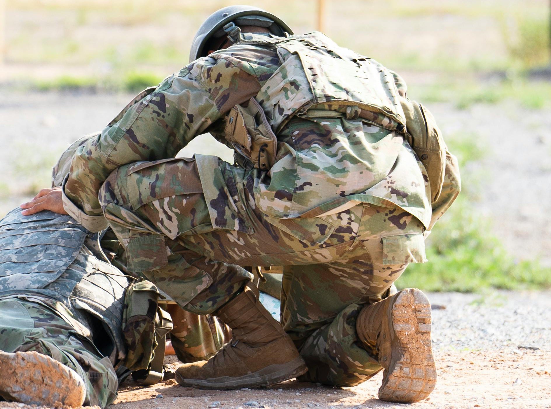 Photo of Persons in Camouflage Uniform Kneeling