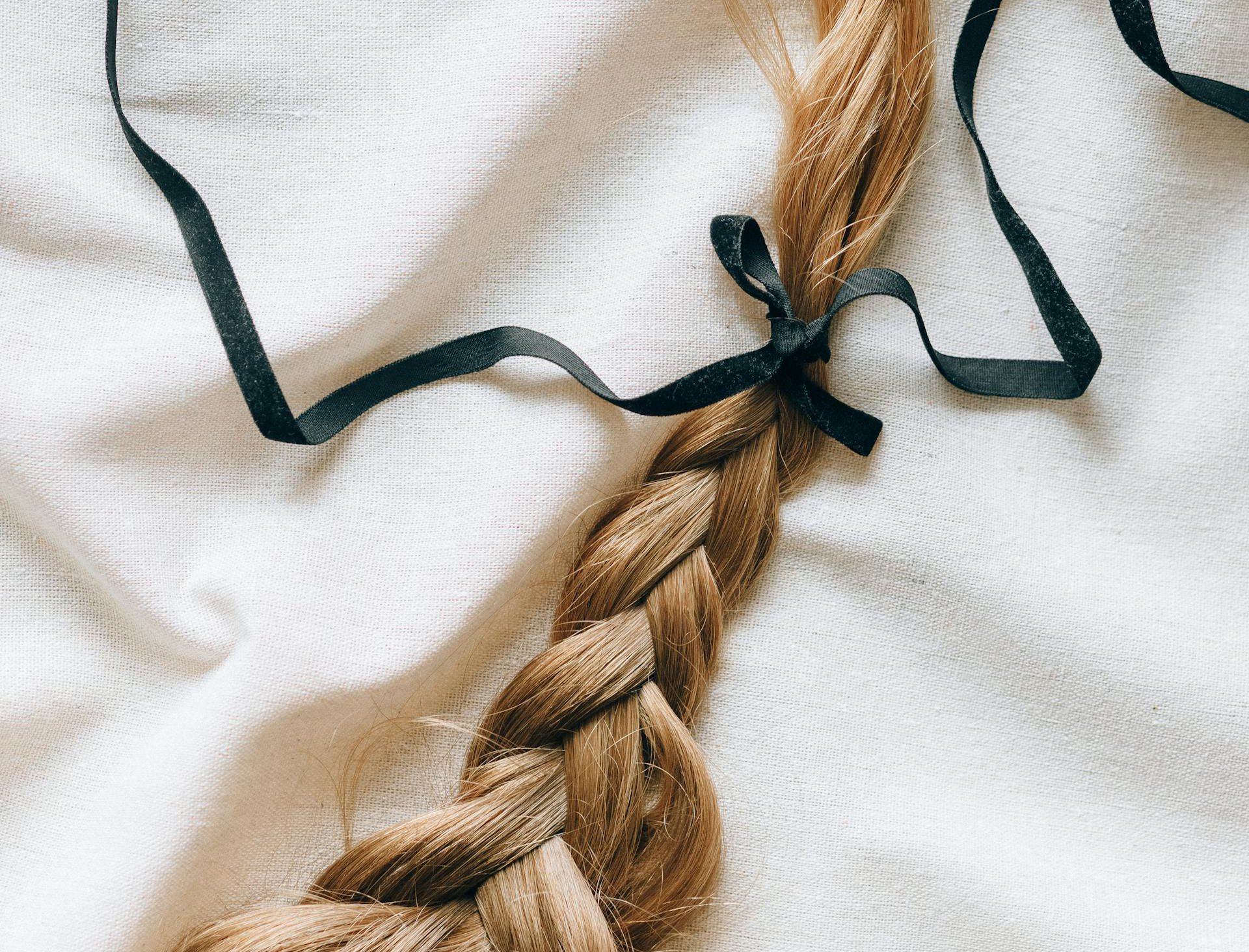 Close Up Photo of Hair with a Black Ribbon