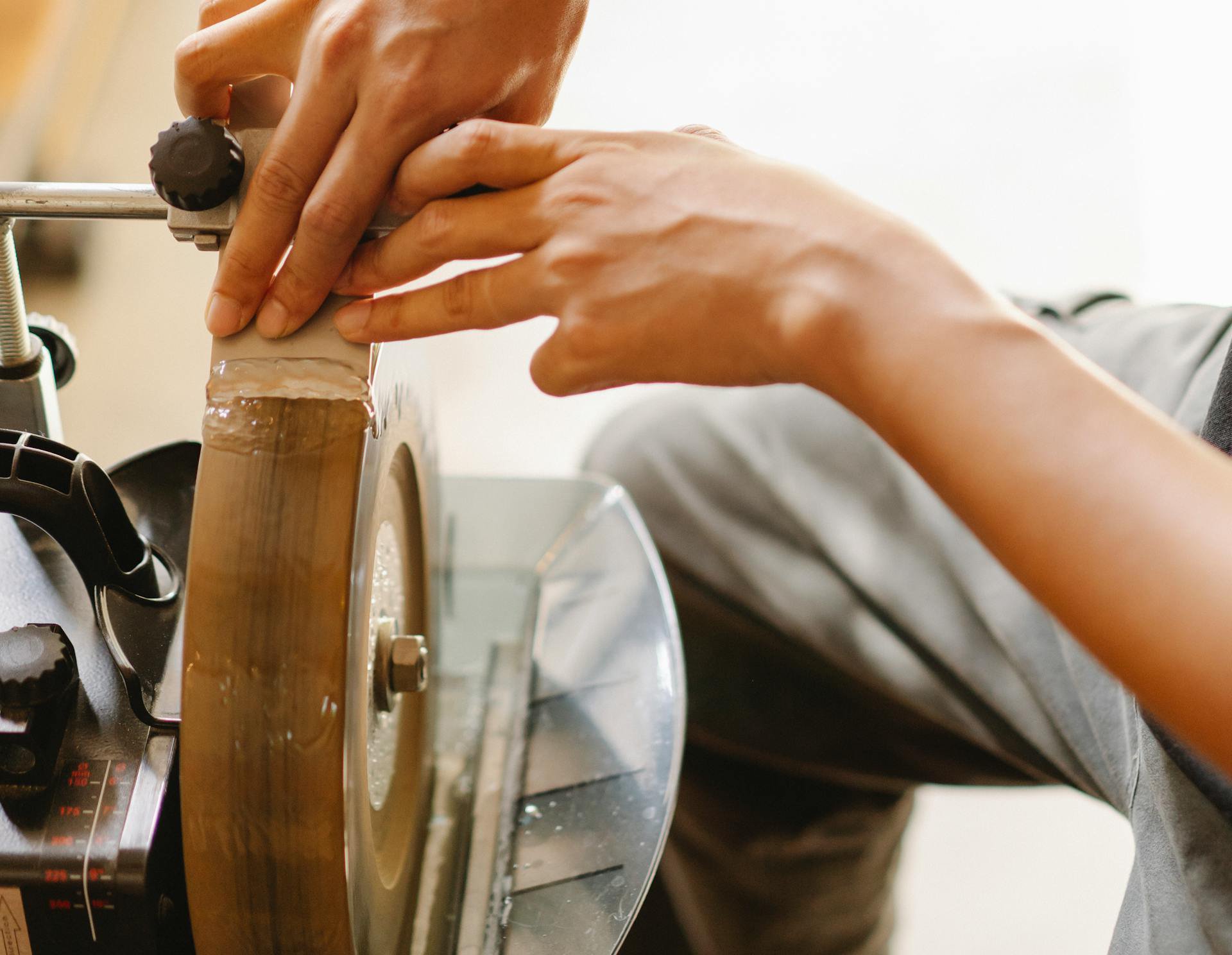 Photo of a person working at sharpening instrument