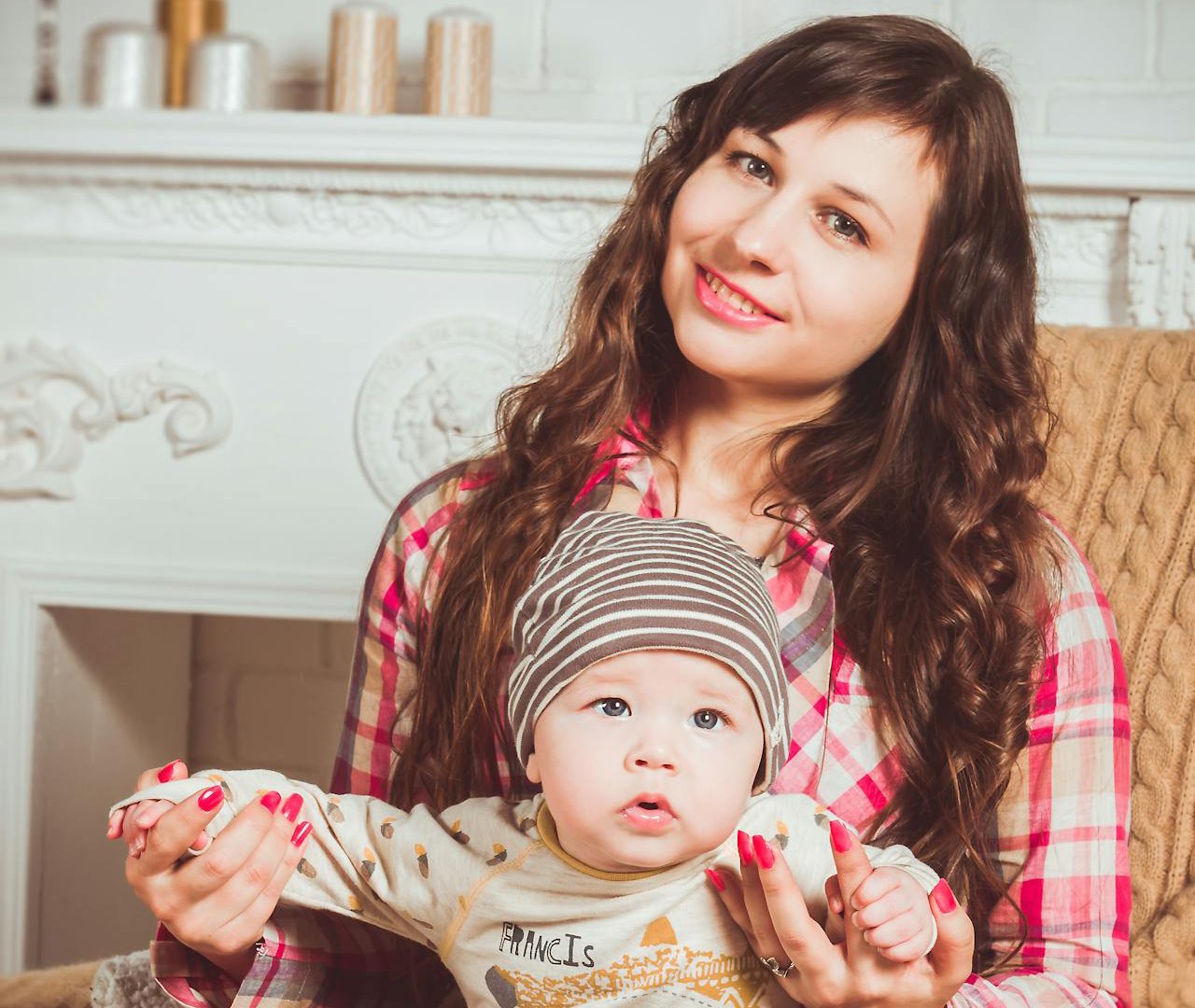 Portrait Photo of a Woman Sitting On Chair Holding Baby