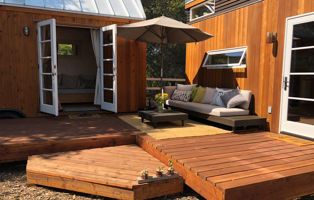 A wooden deck connecting a house