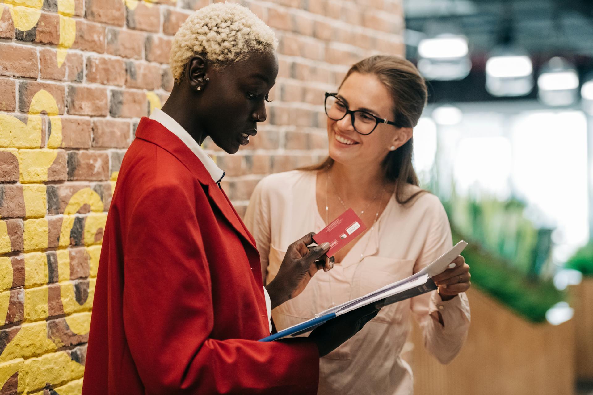 Businesswomen Discussing Payment with credit card