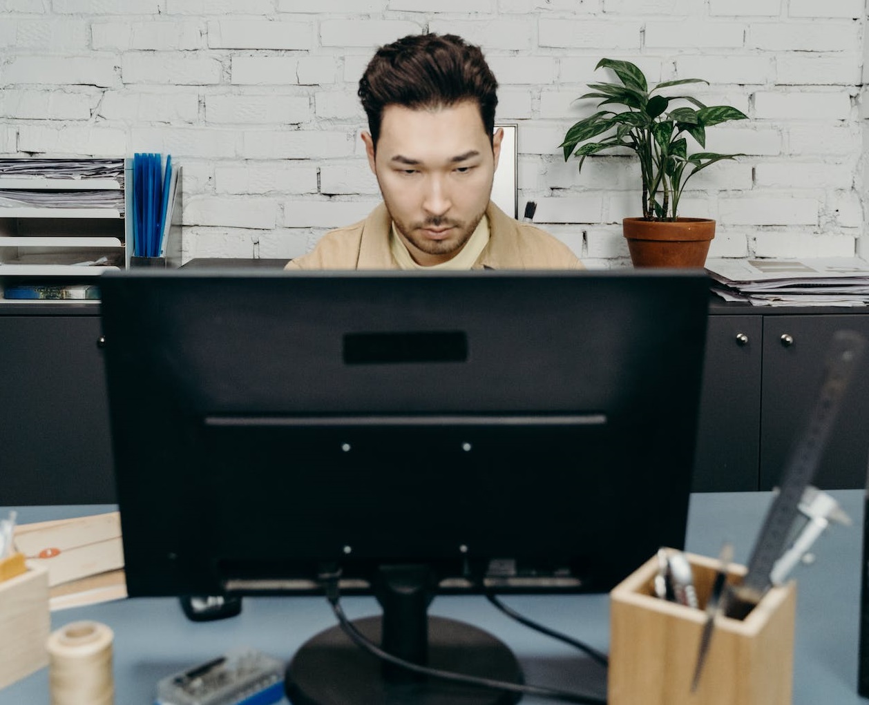 Young man working at his desk.