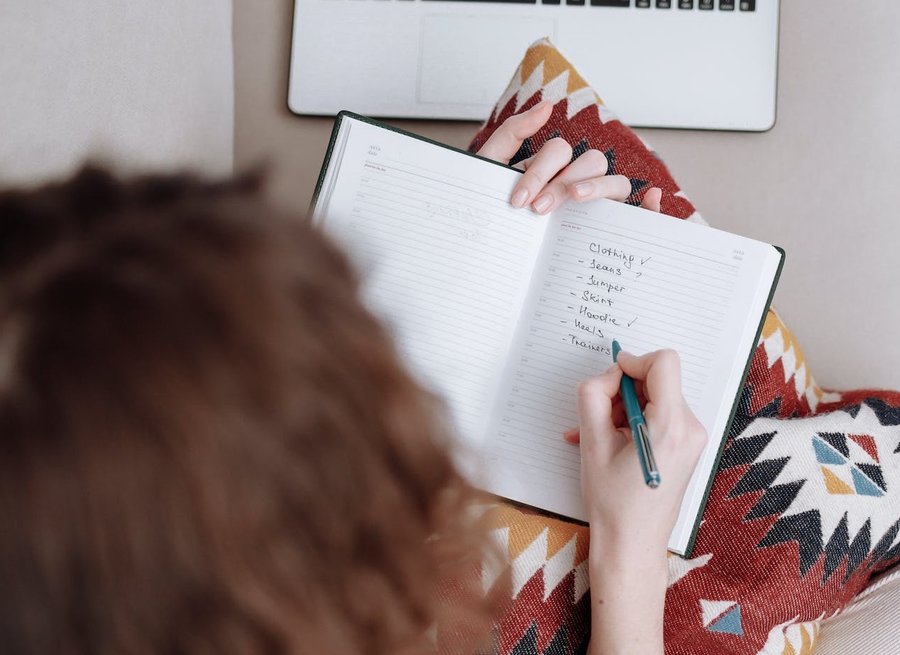 Woman making a list in notebook.
