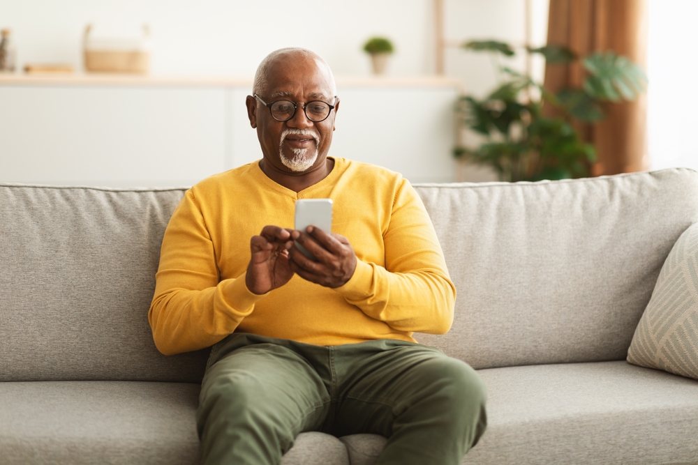 Senior Black Man Using Smartphone