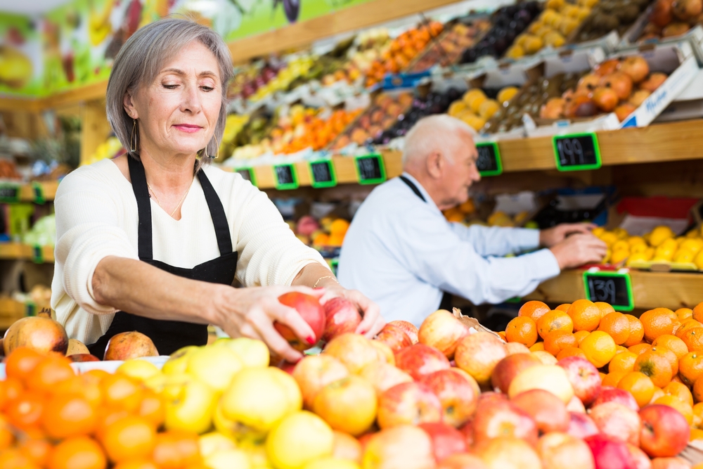 Old man and woman working in store
