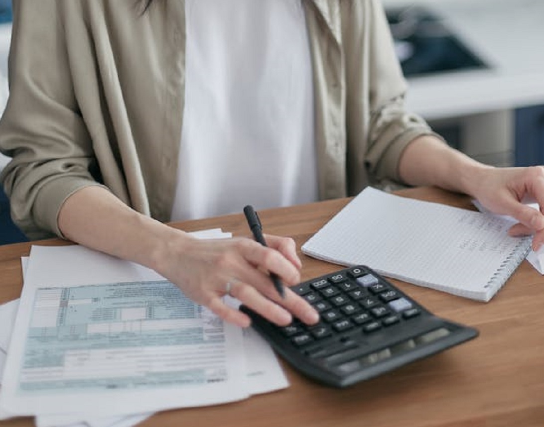 Woman is looking at bills.