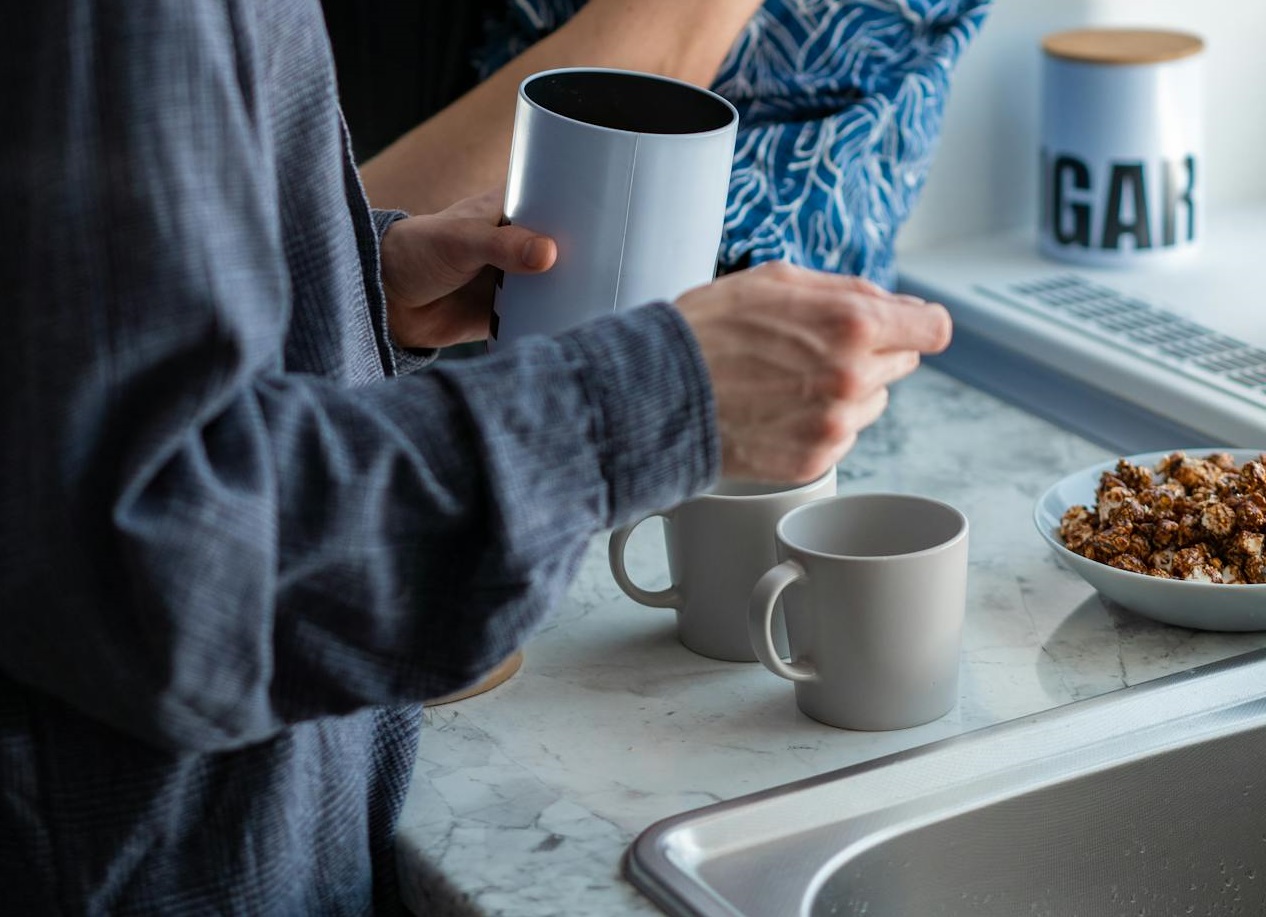 A person is making a coffee at home.