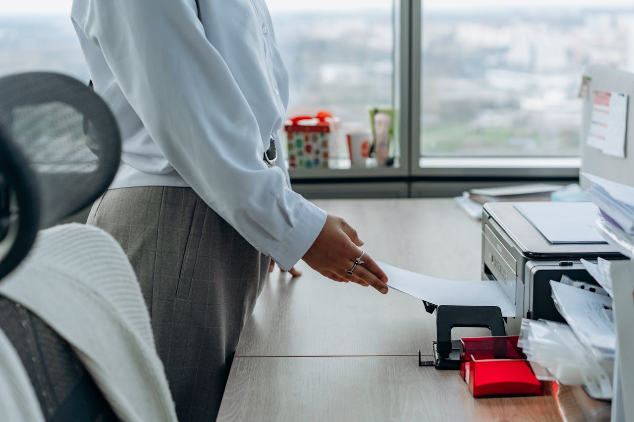 Close up of woman printing a document.