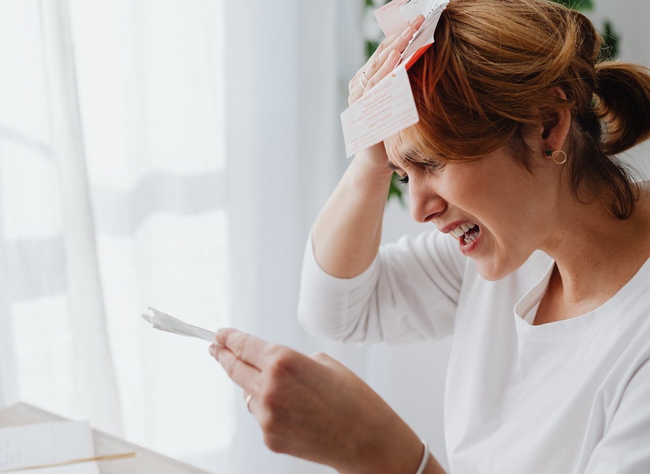 Woman counting money and paying bills.