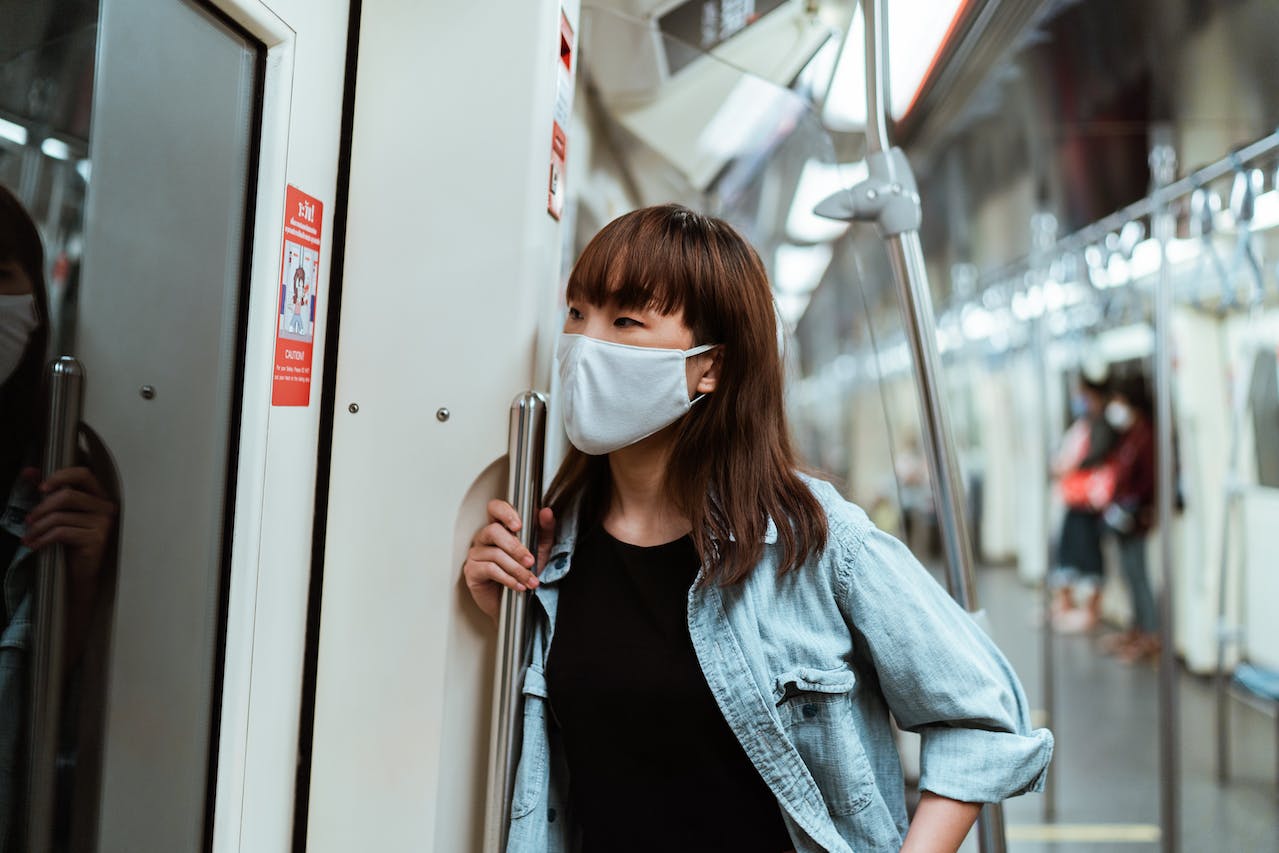 Woman wearing a face mask on the subway.