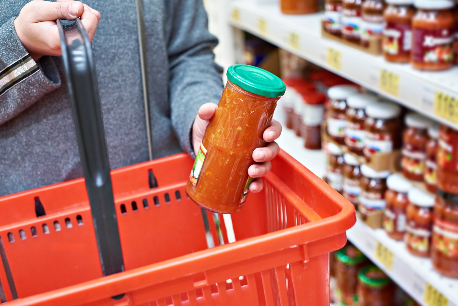 Glass jar of canned vegetables in the hands of the buyer.