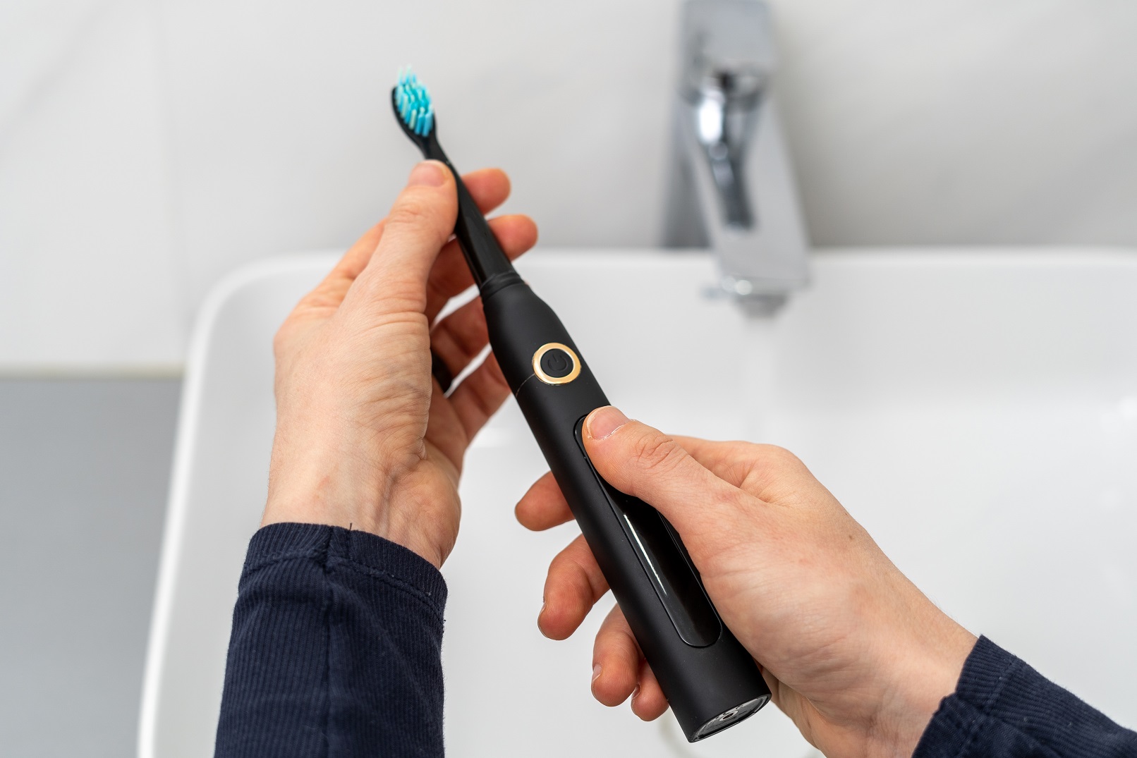 woman hold professional sonic electric toothbrush