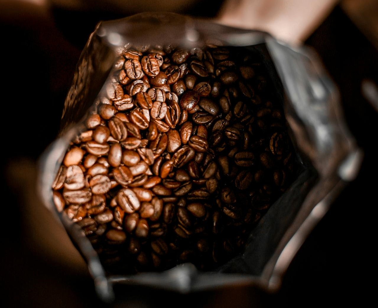 Person with bag full of coffee beans.