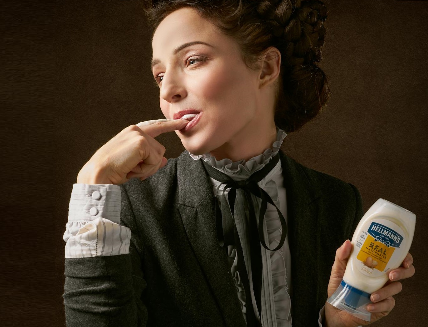 Woman in Black Coat Holding Product Bottle