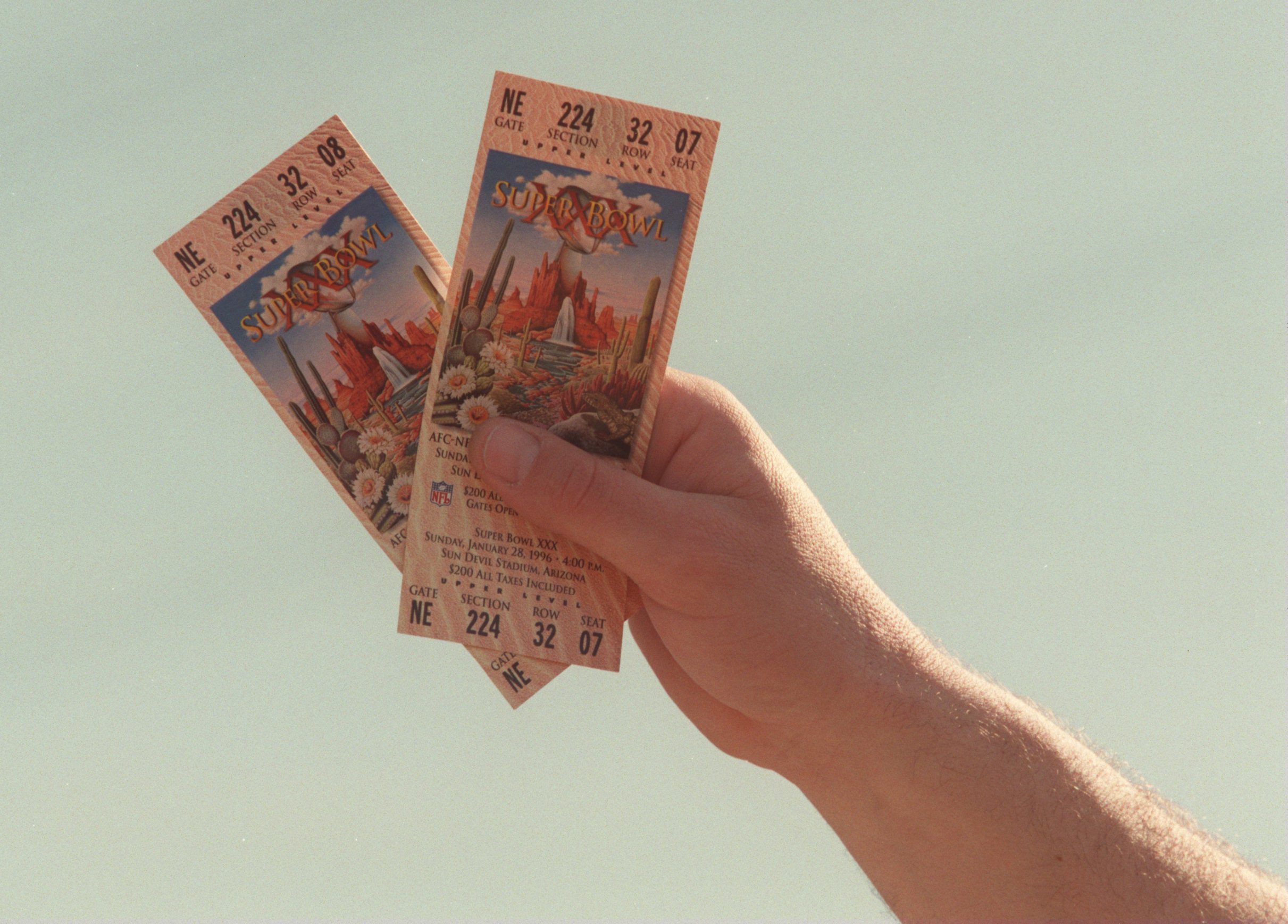 A fan displays two tickets for Super Bowl XXX