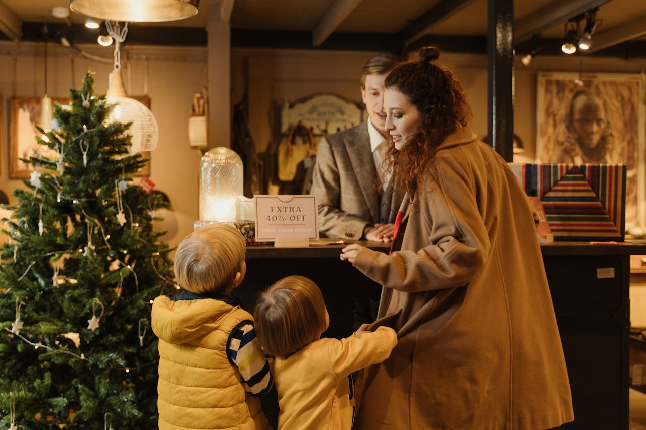 Young Woman with two children inside a store talking to a sales person