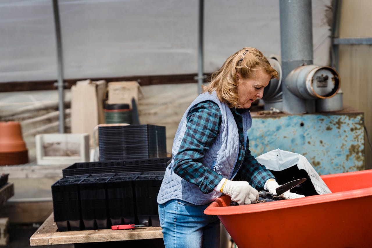 Profile Photo of a senior woman with shovel working in garden