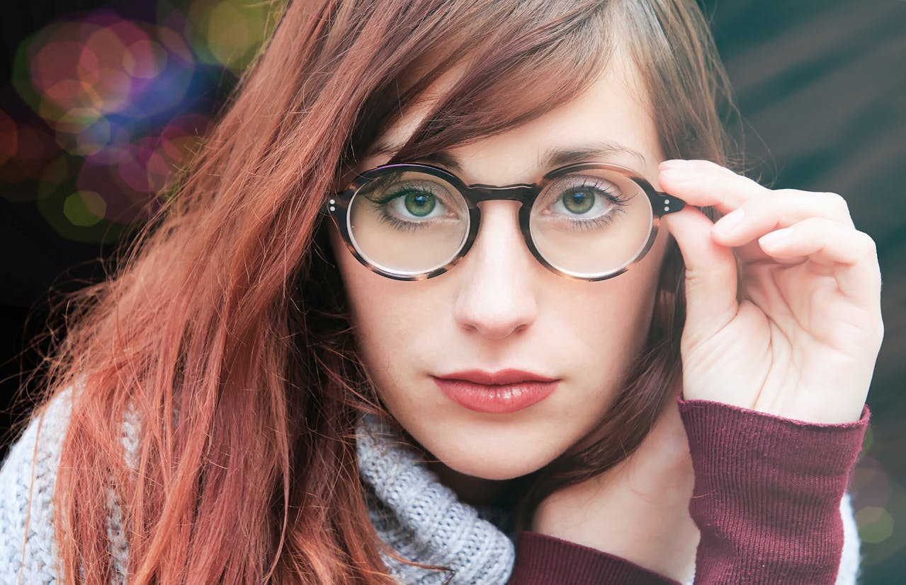 Woman with brown hair wearing eyeglasses facing the camera