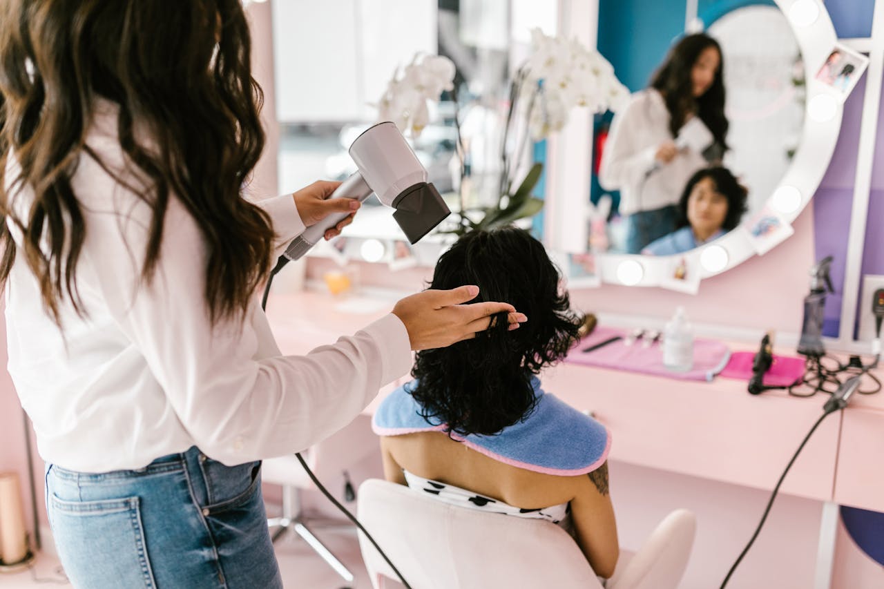 A person getting a blow dry at a hair salon