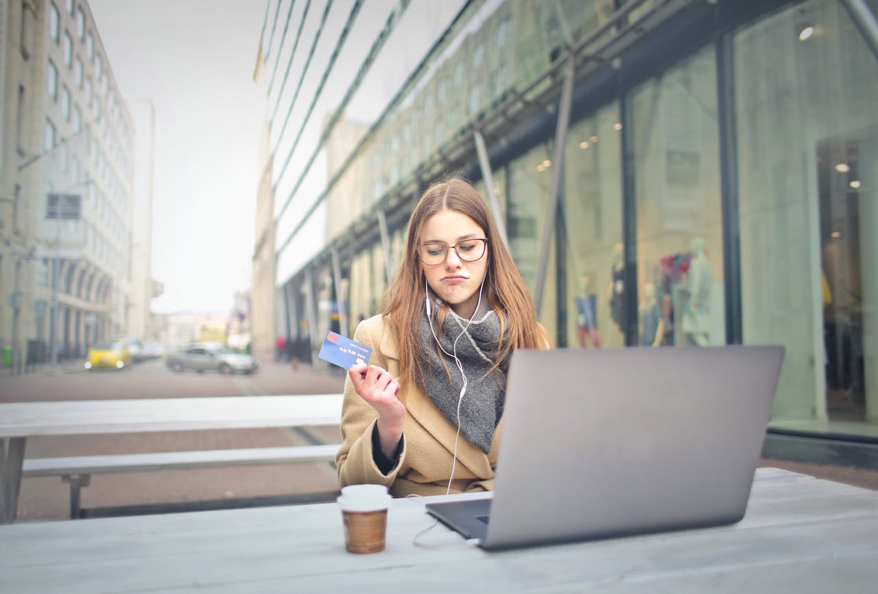 Teenage girl sitting in a cafe shopping online