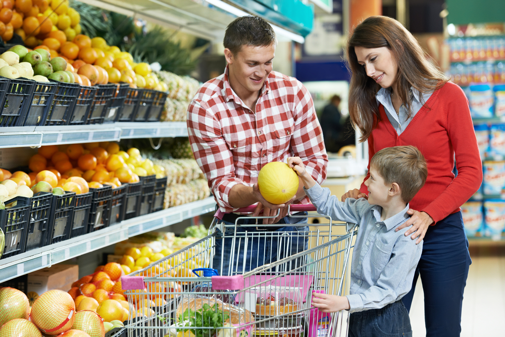 Parents and kid shopping at grocery store