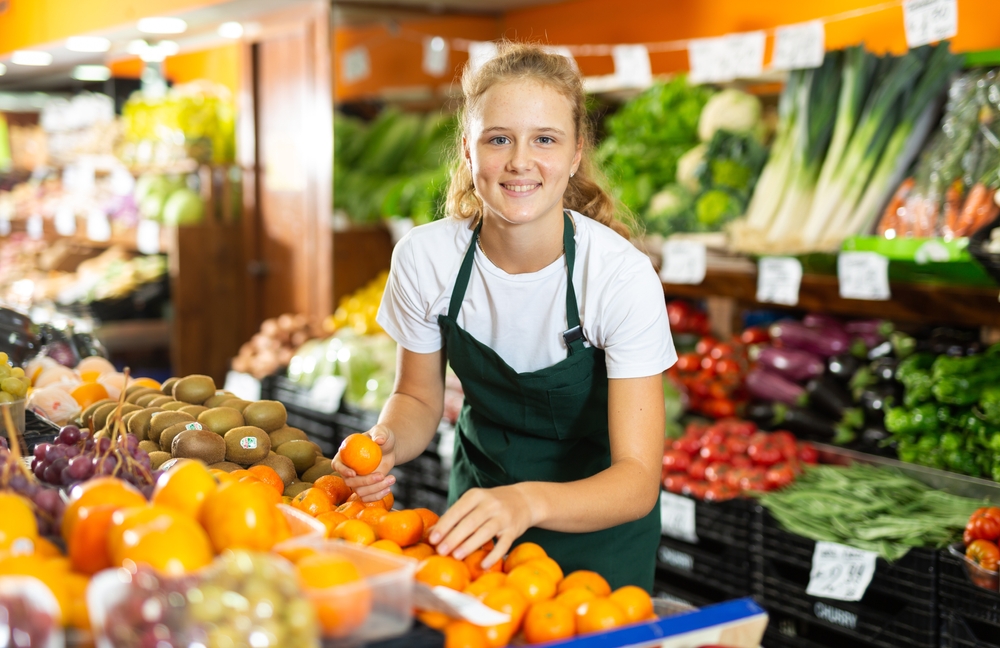Young girl working at a grocery store
