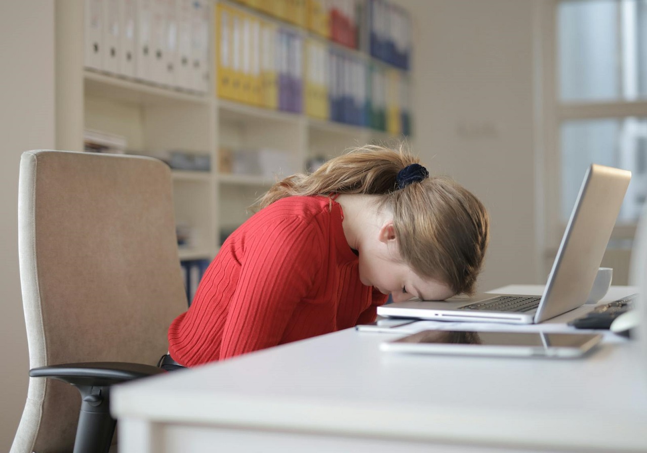Woman Sitting on Chair While Leaning on Laptop
