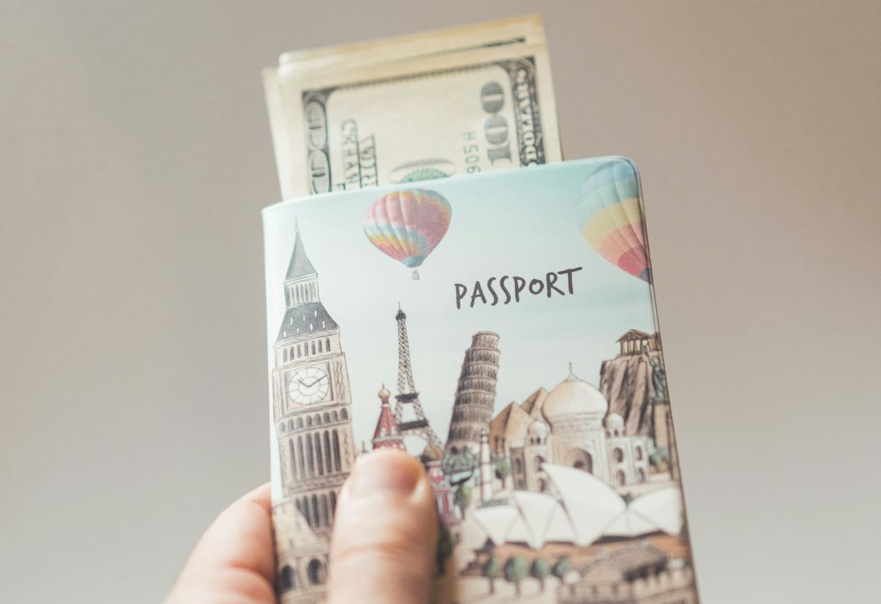 Person with passport with dollars in creative cover