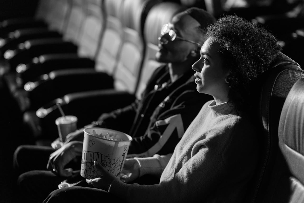 Man and a Woman Watching a Movie Together