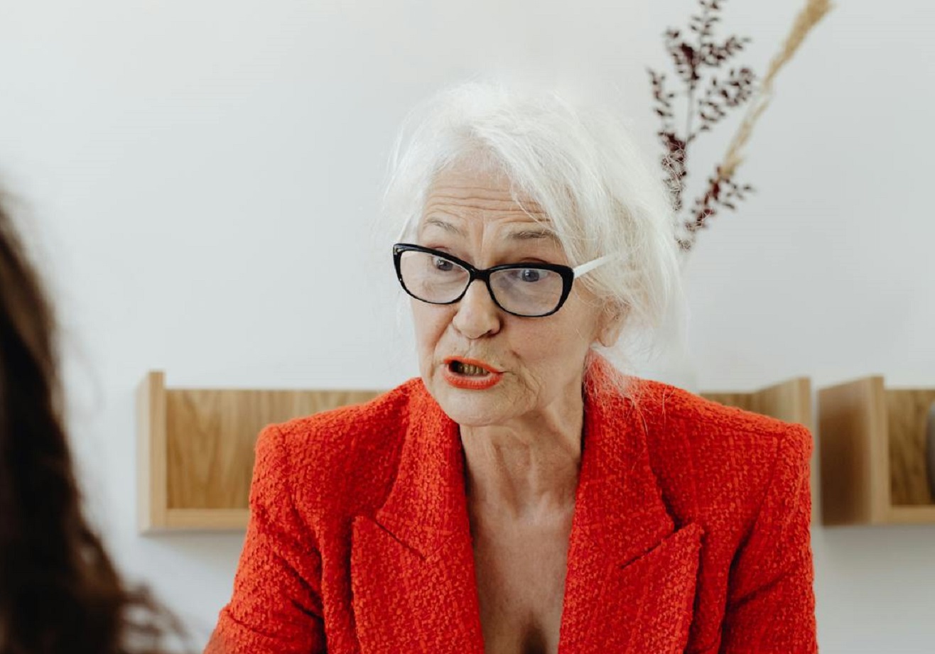 A Gray Haired Woman Wearing Red Blazer