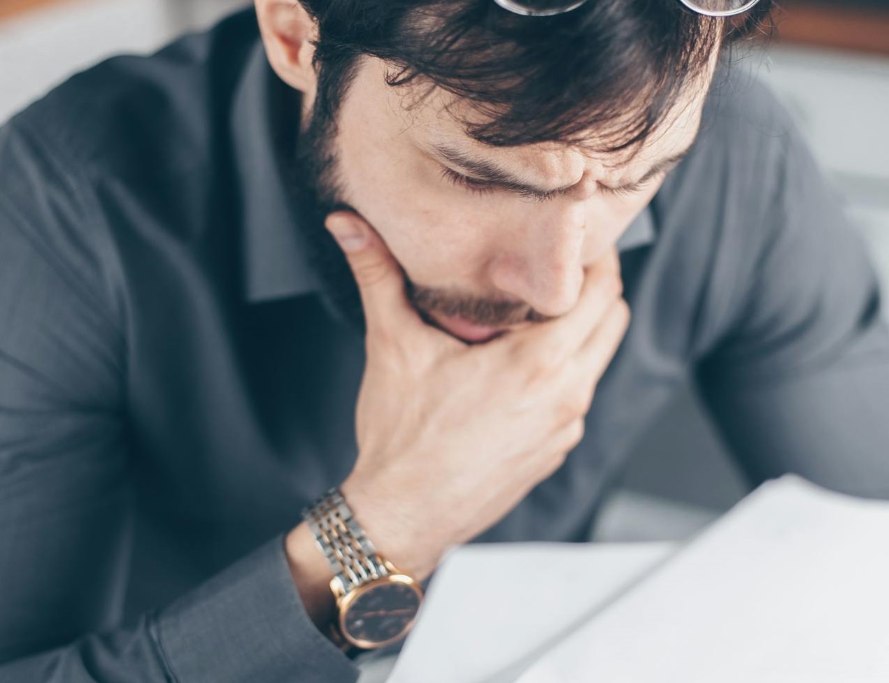 A Man Looking at the White Paper