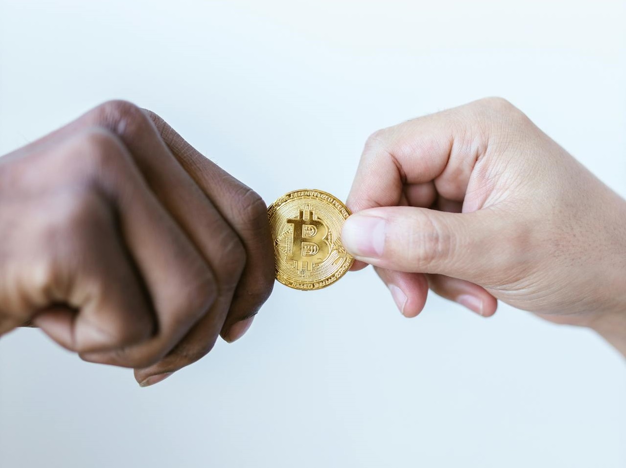 Close-Up Shot of Two People Holding a Crypto Coin.