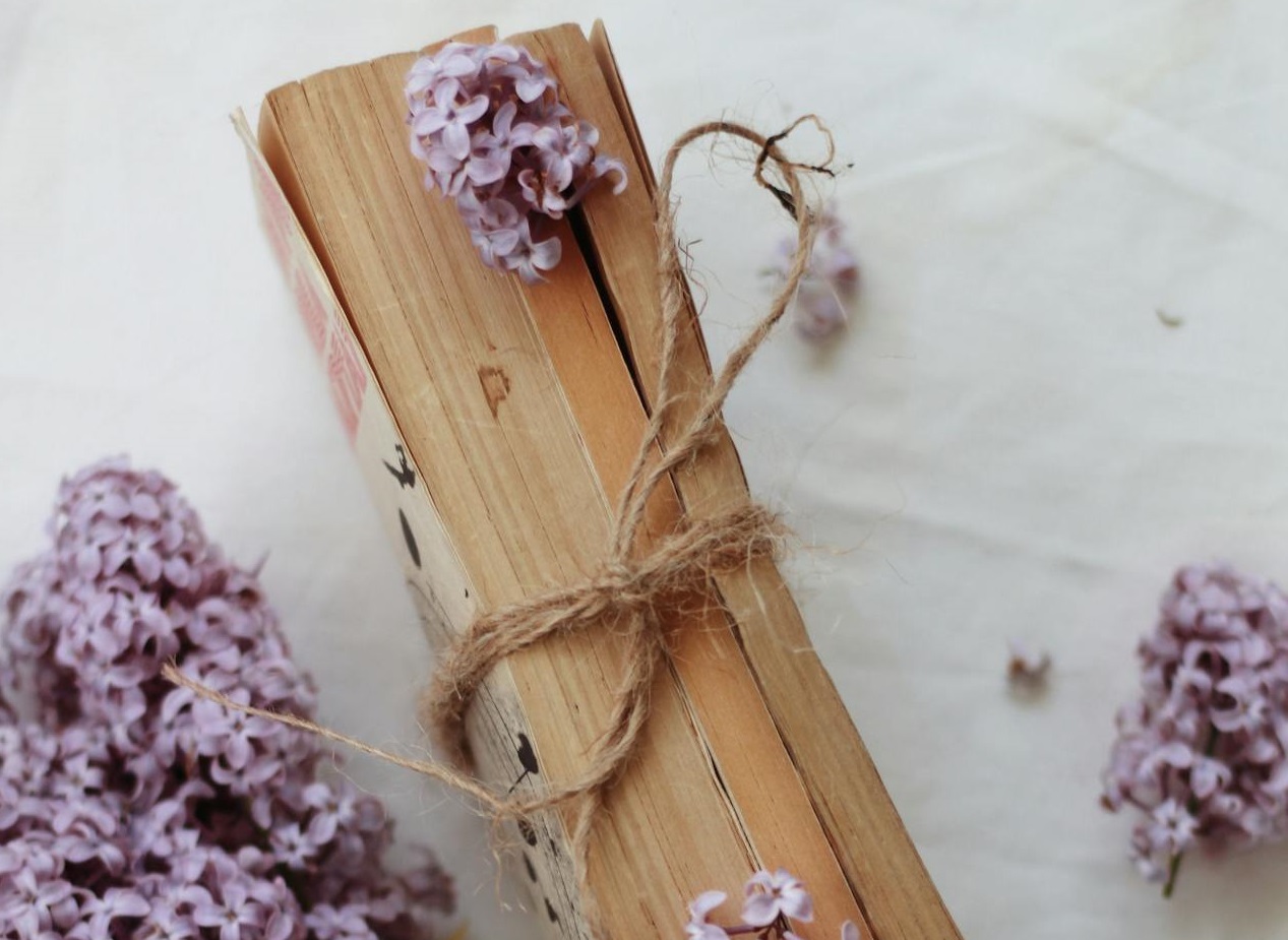 Book on table decorated with flowers