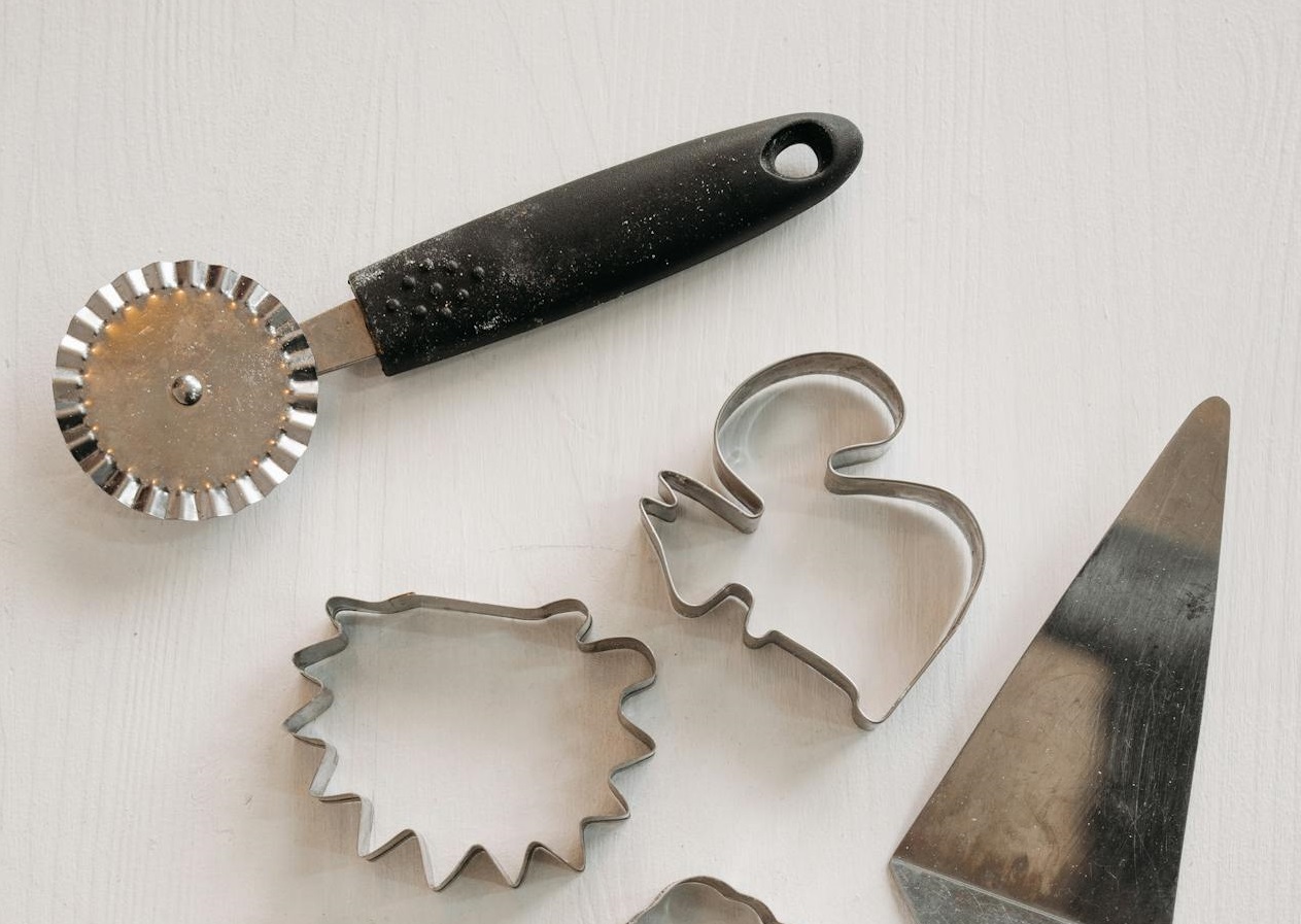 Stainless cookie cutters on White Surface