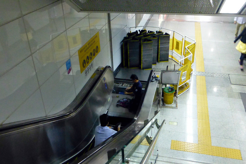 image of a man working on escalator