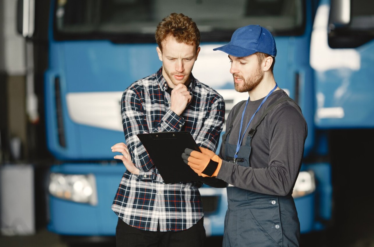 image of a two man talking in front of truck