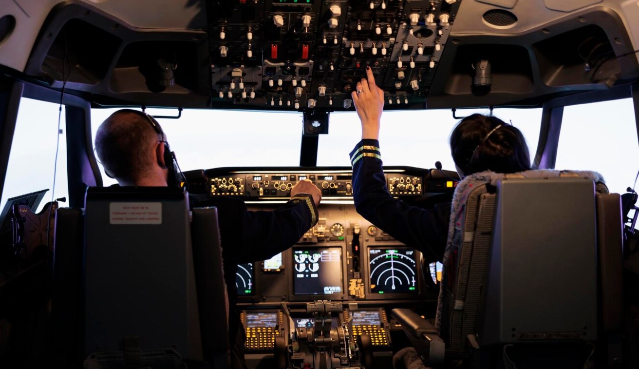 Airline crew fixing altitude level and with control panel buttons