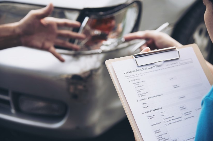 Insurance agent working during on site car accident
