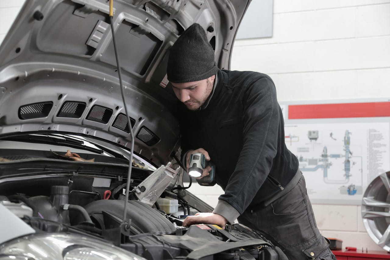 man checking the car with light