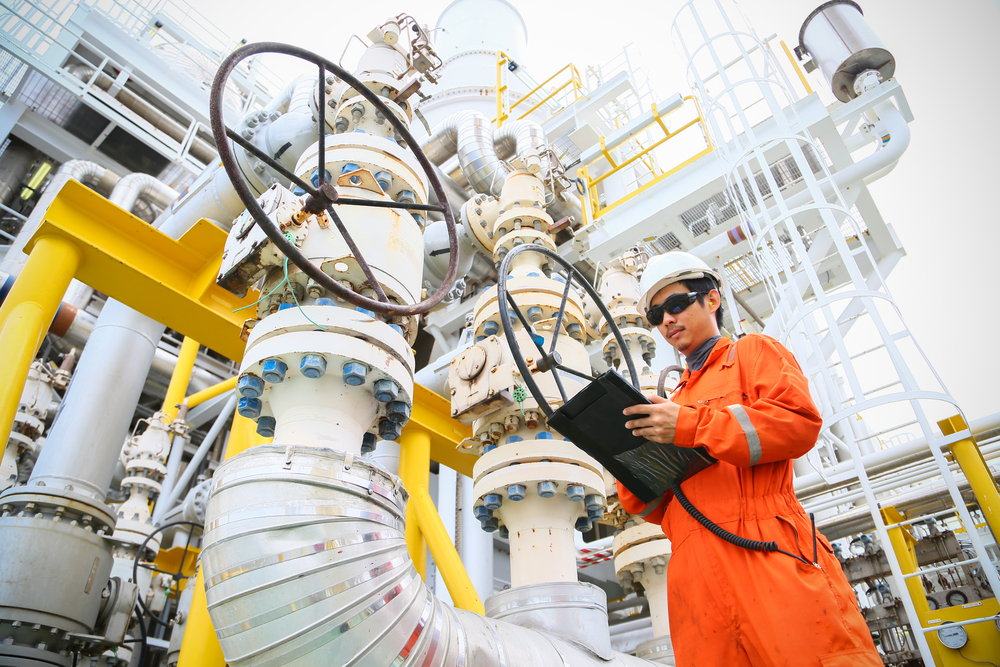 image of a man working in a gas and oil factory