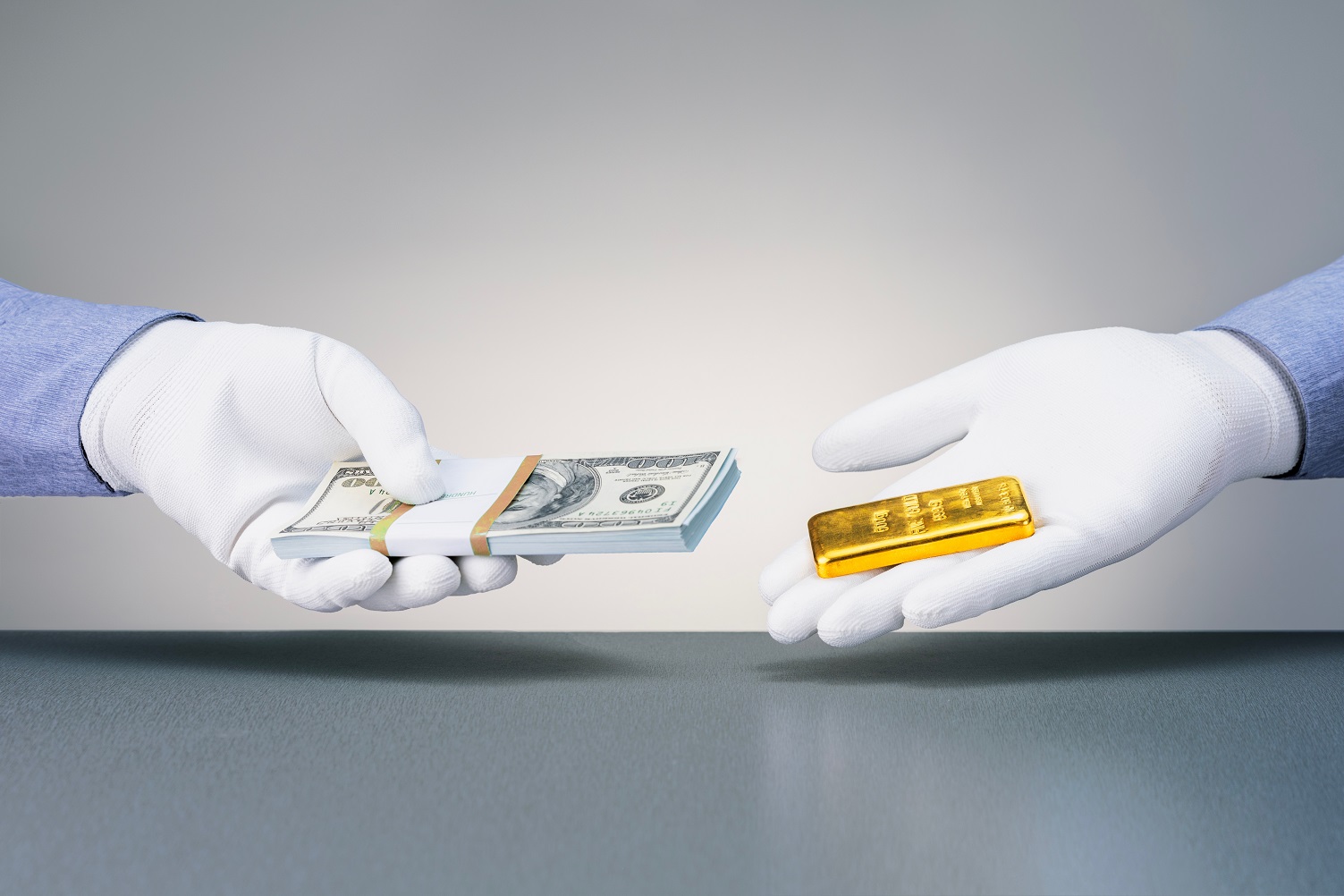 Man holding gold bar and man holding dollar banknotes.